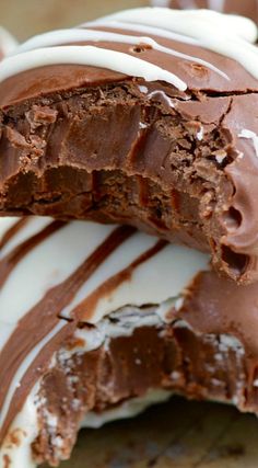 two pieces of chocolate cake with white frosting