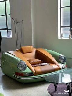 a green and brown car sitting in a living room next to a glass table