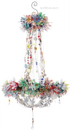 a chandelier with beads and flowers hanging from the ceiling