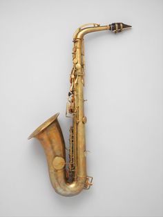 an old saxophone is sitting on the wall