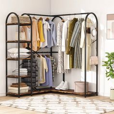 an open closet with clothes and shoes hanging on the rack, next to a potted plant