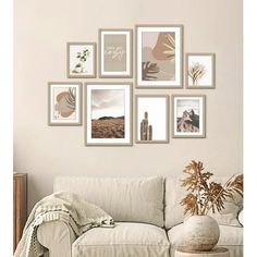 a living room filled with white furniture and pictures on the wall above it's couch