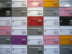 many different colored mail boxes with numbers on them
