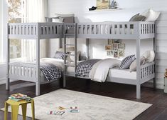 a bedroom with two bunk beds and a rug on the floor