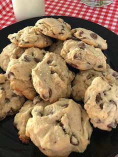 chocolate chip cookies on a black plate with the title text overlay reads the flufflest chocolate chip cookies