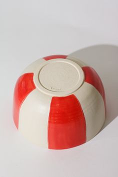 a red and white object on a white surface