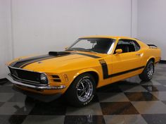 a yellow car is parked on a black and white checkered floor