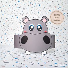 a paper cut out of a hippo with blue eyes on it's head