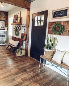 a living room filled with furniture and decor on top of hard wood floored floors