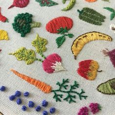 a close up of some embroidered items on a piece of cloth