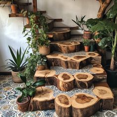 a set of wooden steps made out of tree trunks and logs with plants growing on them