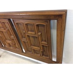 an old wooden cabinet with decorative carvings on the front and side panels, made out of wood