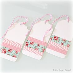 three tags with pink and green flowers on them