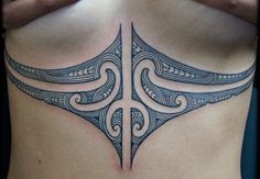 a woman's chest with an intricate tattoo design on it