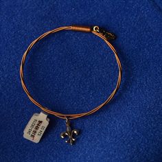 Strung Inc Fluer De Lis Charm Bracelet. Made Out Of Authentic Guitar Strings In The Usa. Complete W/ Strung Bag And Authenticity Card. Guitar String Bracelet, Fluer De Lis, Guitar Strings, String Bracelet, Gold Red, Womens Jewelry Bracelets, Red Gold, Making Out, Flour