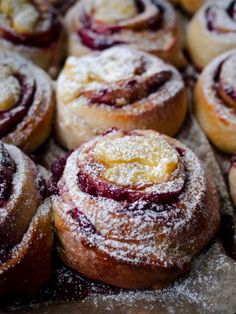 some very tasty looking pastries with powdered sugar on top and cranberry filling