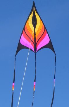 a colorful kite is flying high in the blue sky on a clear, sunny day