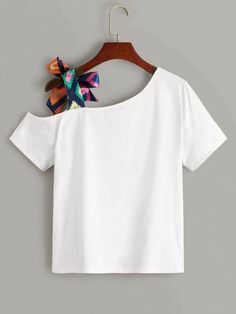 a white t - shirt with a colorful bow on it