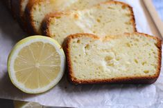 slices of lemon pound cake sitting next to a sliced lemon