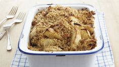 a casserole dish with apples and crumbs in it on a table
