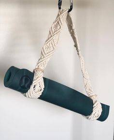 a green yoga mat hanging from a hook