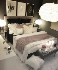 a bedroom with white fur and lights on the bed