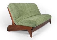 a green couch sitting on top of a wooden frame