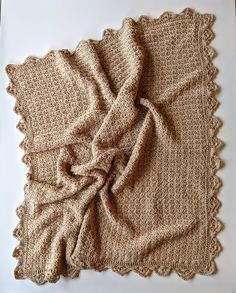 a crocheted blanket on top of a white table