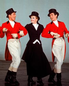 three men in red and white outfits standing next to each other with their hands on their hips