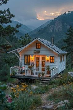 a small white house sitting on top of a lush green hillside