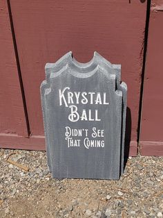 a tombstone sitting in front of a red door that says krystal ball didn't see that coming