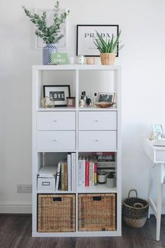 a white bookcase filled with books next to a desk