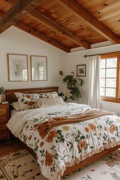 a large bed in a bedroom next to two windows with wood trimmings on the ceiling