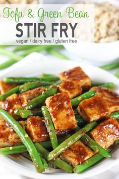 tofu and green bean stir fry on a white plate