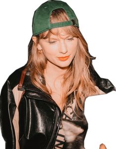 a woman with long hair wearing a green hat and black leather jacket is posing for the camera