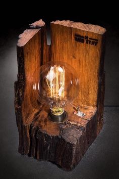 a light bulb sitting on top of a piece of wood