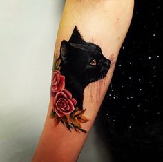 a black cat with roses on its arm