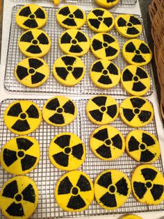 some cookies that have been decorated to look like radioactive symbols are on a cooling rack