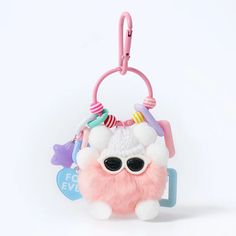 a pink and white stuffed animal with sunglasses on it's head hanging from a key chain