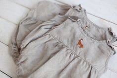 * Handmade from 100% natural washed and soft medium weight OEKO-TEX certified linen. * Hand embroidered. * Coconut buttons on the shoulders and snaps in the bottom for an easy and comfortable change. * Suitable for a baby up to 6 months old. * Washed and soft medium-weight linen (160g). * Care: Machine wash 40o C, tumble dry low. * Clothes made of linen are perfect to wear in different conditions: in hot weather, it cools and in cold weather, it warms. * Linen is long-lasting. Possible to pass d Overalls For Kids, White Baby Romper, Toddler Girl Romper, Linen Overalls, Baby Overall, Jumpsuit For Kids, Neutral Baby Clothes, Rompers For Kids, Linen Romper