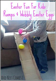 a little boy playing with some balls in a cardboard box