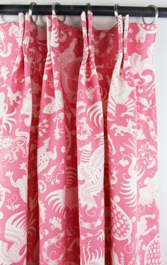 pink and white curtains with dragon designs on them