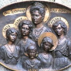 an image of a plaque with women and children on it's side in bronze