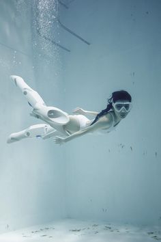 a woman wearing goggles is floating in the water