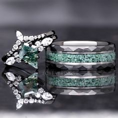 two wedding bands with green and white stones on them, next to an emerald colored ring