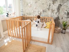 a baby in a crib with a stuffed cow