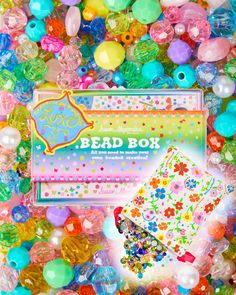 the box is full of colorful beads and some sort of bead on it's side