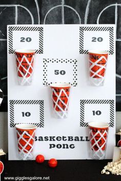 some cups are sitting on top of a board with numbers and candy canes around them