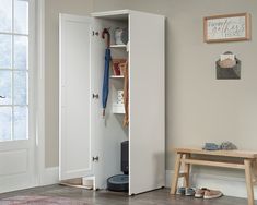 an open closet with shoes and other items on the floor in front of a window