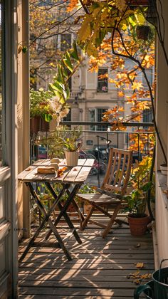 an outdoor table and chairs on a porch with potted plants in the sun light